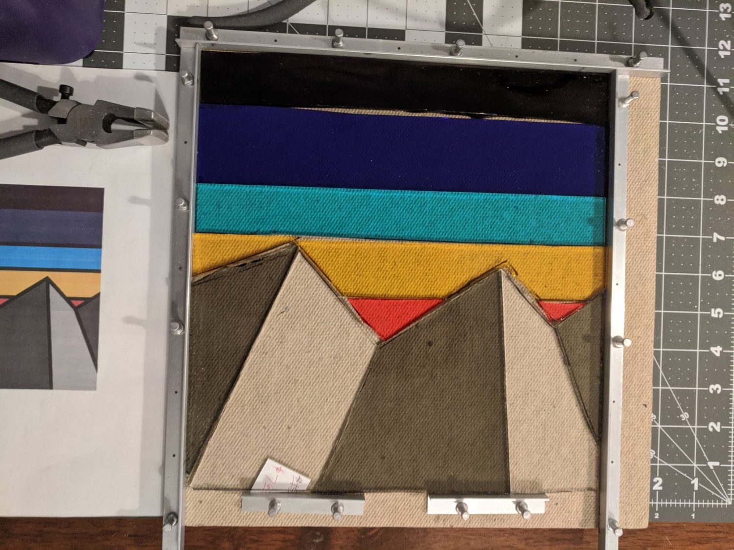 Stained glass is laid out on a table to form a multicolored mountain design. The work-in-progress craft inspiration for the vibrant “stained glass” look of the 3D storm tracks. (Design credit: Silvia Casas) Stained glass is laid out on a table to form a multicolored mountain design. The work-in-progress craft inspiration for the vibrant “stained glass” look of the 3D storm tracks. (Design credit: Silvia Casas)
