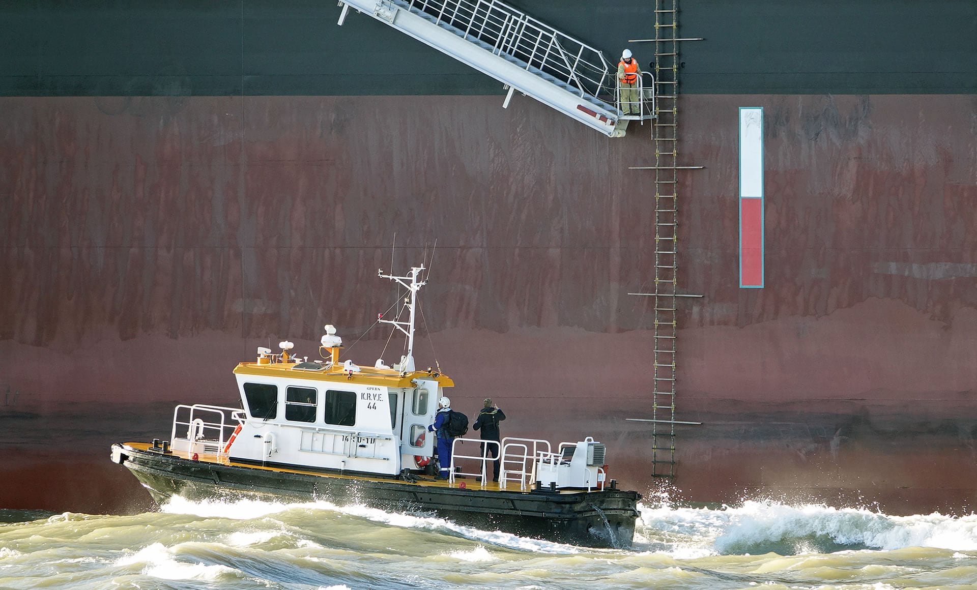 A specialized local pilot is delivered to a large vessel. A specialized local pilot is delivered to a large vessel.