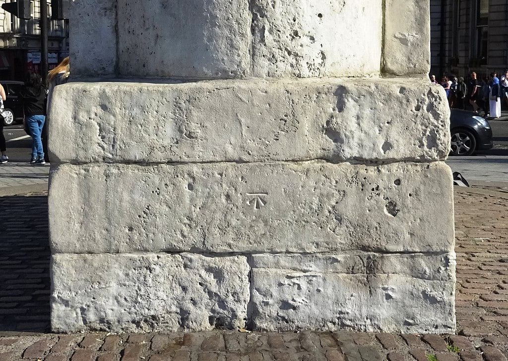 Ordnance Survey benchmark visible on the plinth of the statue of King Charles I in Trafalgar Square, London. This statue stands at the former location of the medieval Charing Cross, and marks the notional centre of London from which mileages are measured. Ordnance Survey benchmark visible on the plinth of the statue of King Charles I in Trafalgar Square, London. This statue stands at the former location of the medieval Charing Cross, and marks the notional centre of London from which mileages are measured.