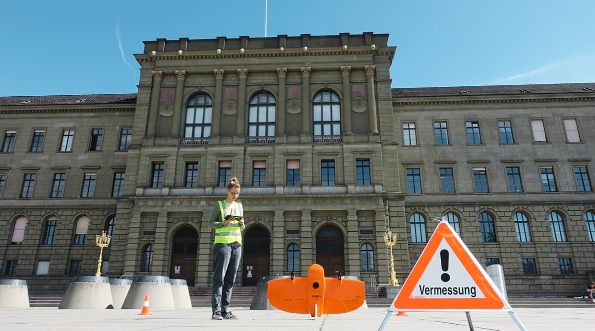 Woman stands in front of drone