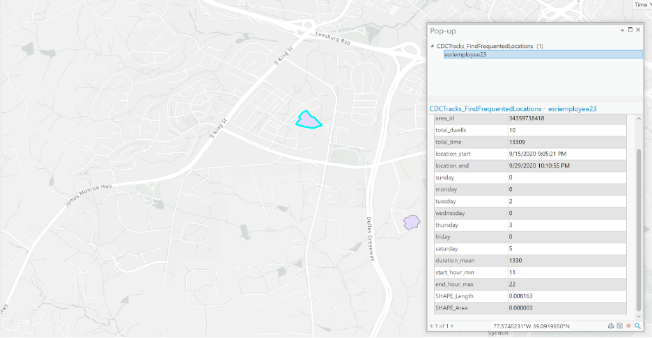 Output from the Find Frequented Locations geoprocessing tool, two polygon features on a map with the attribute table open.