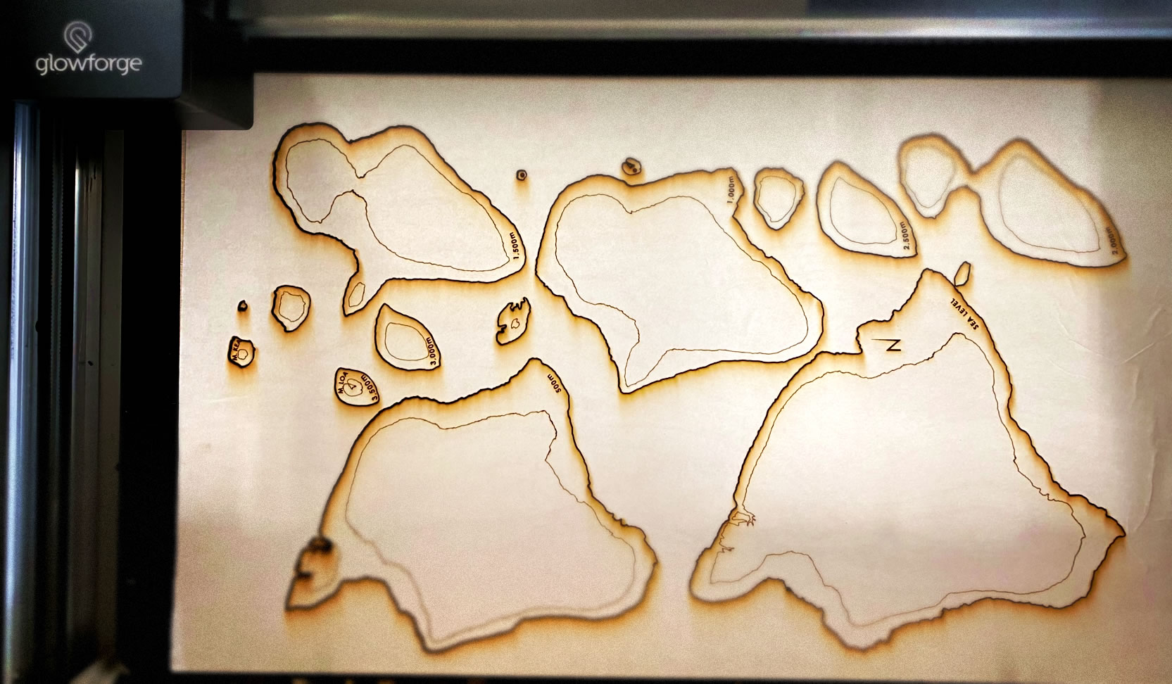 Laser cutter with contours cut and stacking reference lines etched.