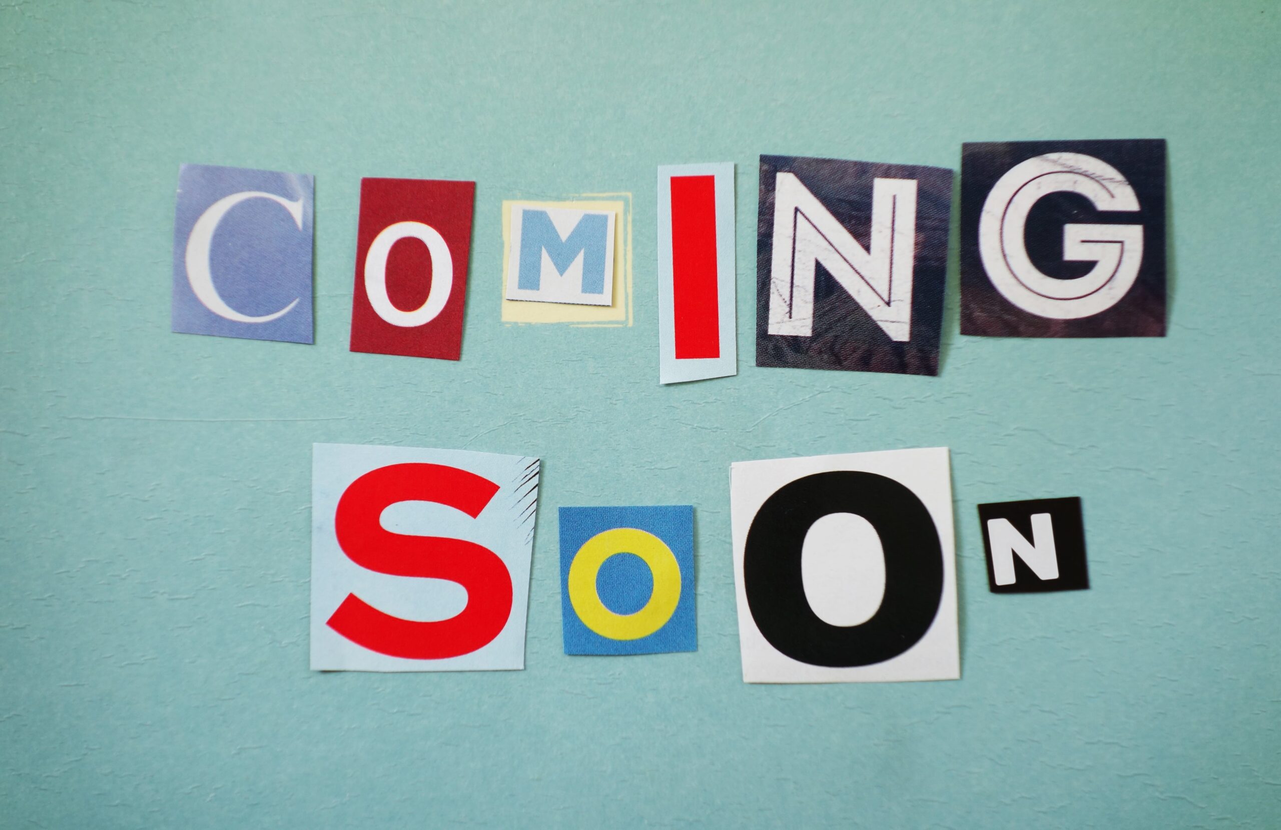 Coming Soon text spelled out in assorted paper letters Coming Soon text spelled out in assorted paper letters