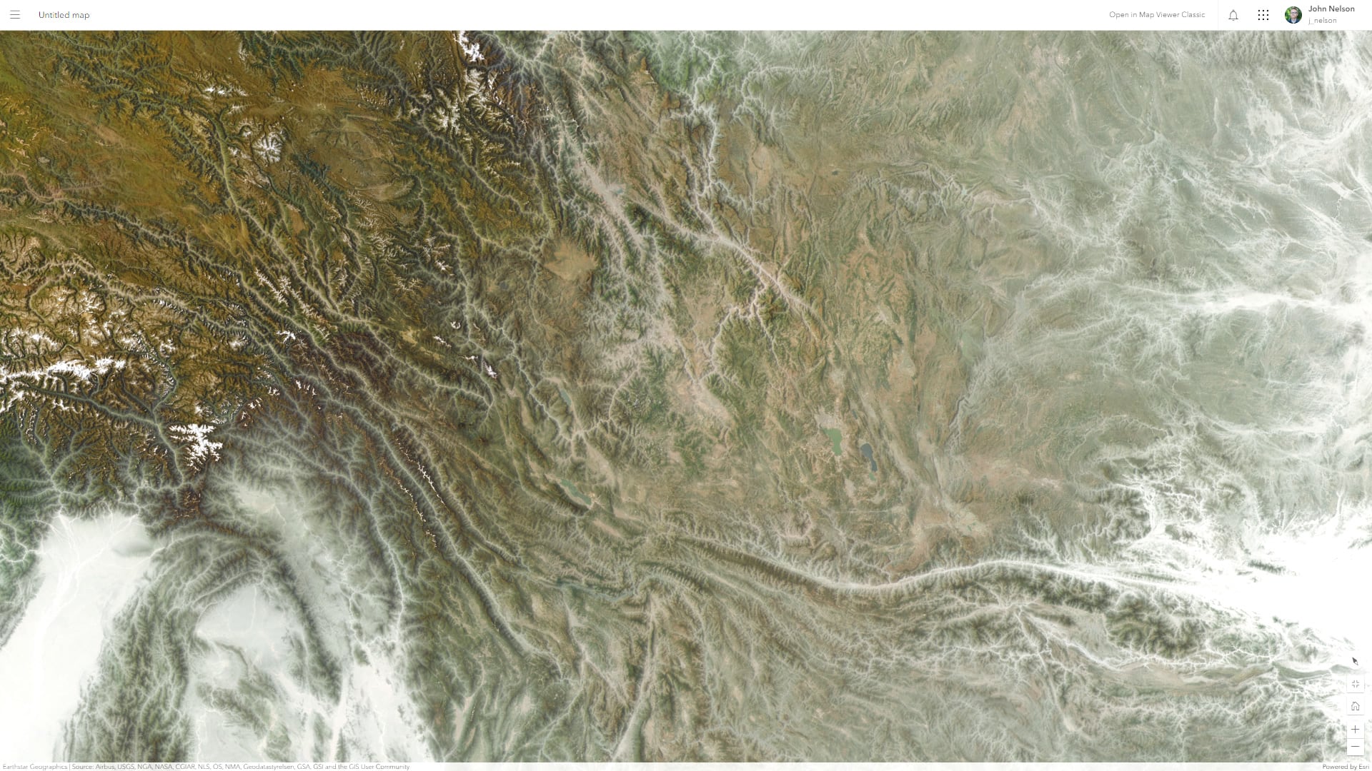 ArcGIs Online imagery basemap with a terrain-informing mist effect.