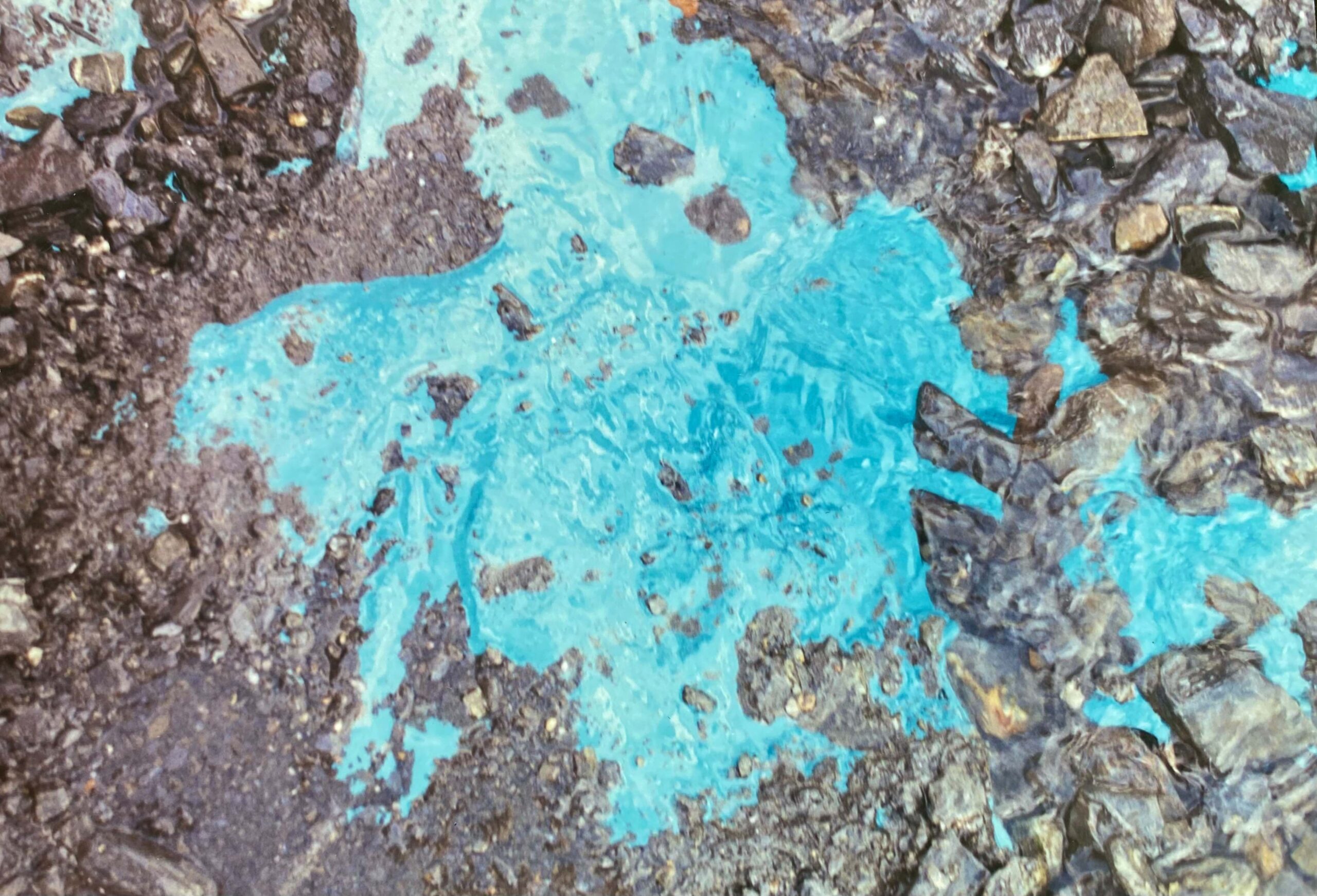 revealed view of glacial ice amidst surface gravel. revealed view of glacial ice amidst surface gravel.