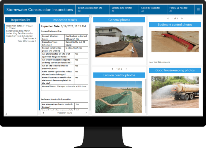 Computer monitor opened to a dashboard app showing completed inspection results and construction site photos.