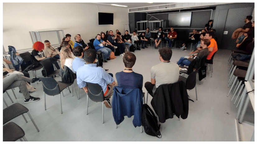 Photo of the Open Space on communities showing about thirty attendees seated in a circle.