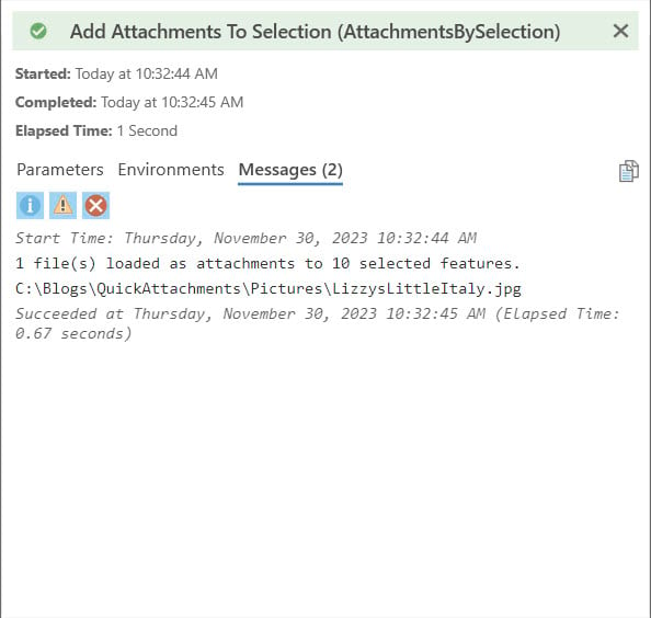 Dialog window with green banner showing a message of a successful process loading attachments to selected features.
