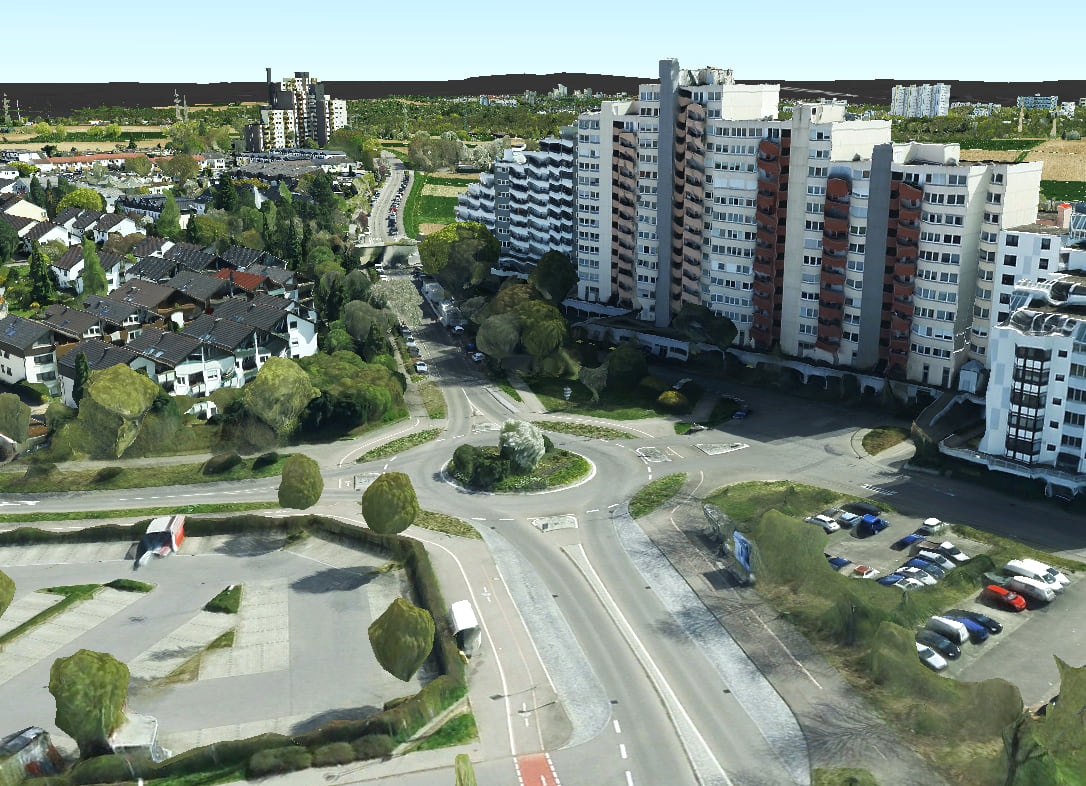 A 3D tiles layer showing a traffic circle, a large building, small residential houses, and trees.