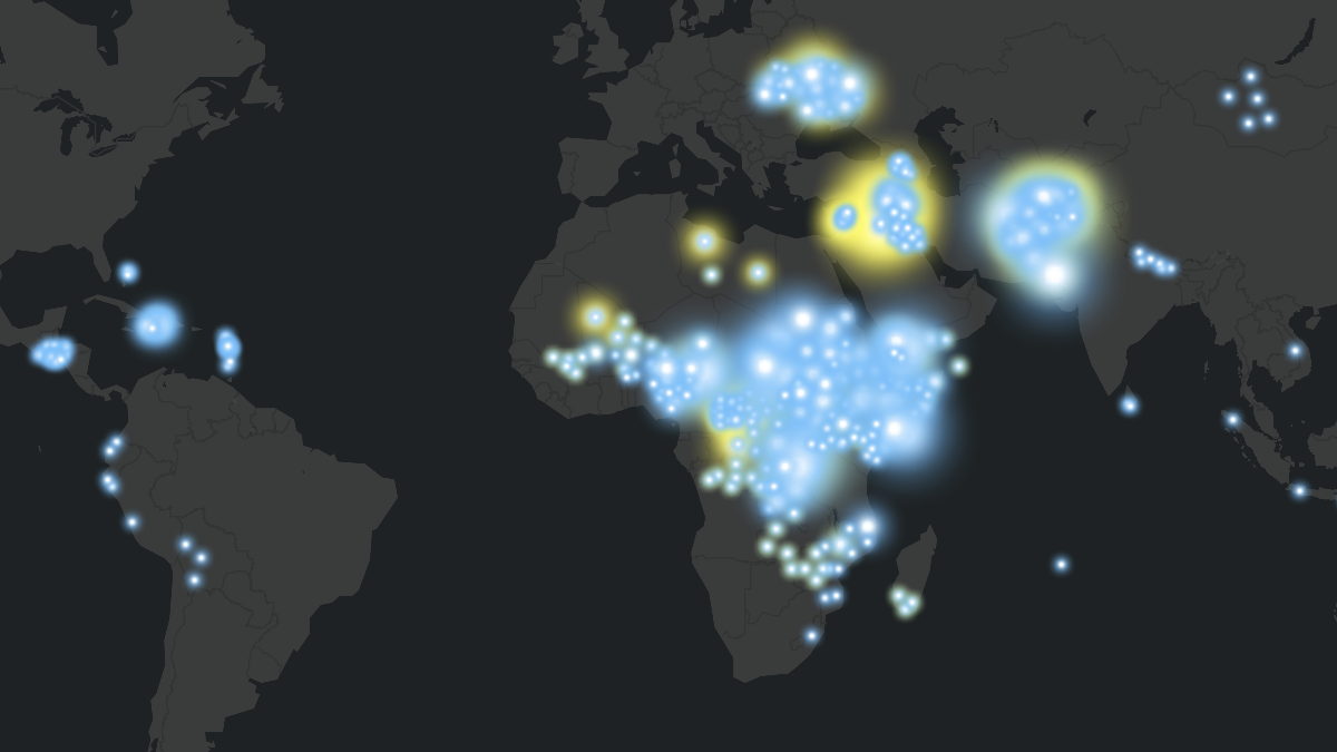 Black silhouette world map with bright yellow and blue circles marking displacement data points. Large clusters appear across Africa, Eastern Europe, and the Middle East, with smaller circles scattered in other regions.