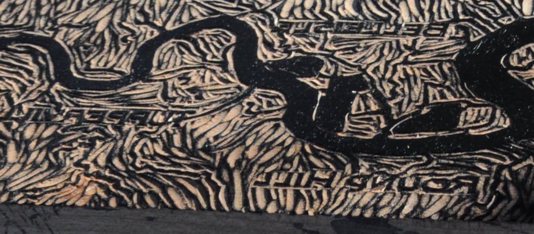 Up close view of map carved into wood. Up close view of map carved into wood.
