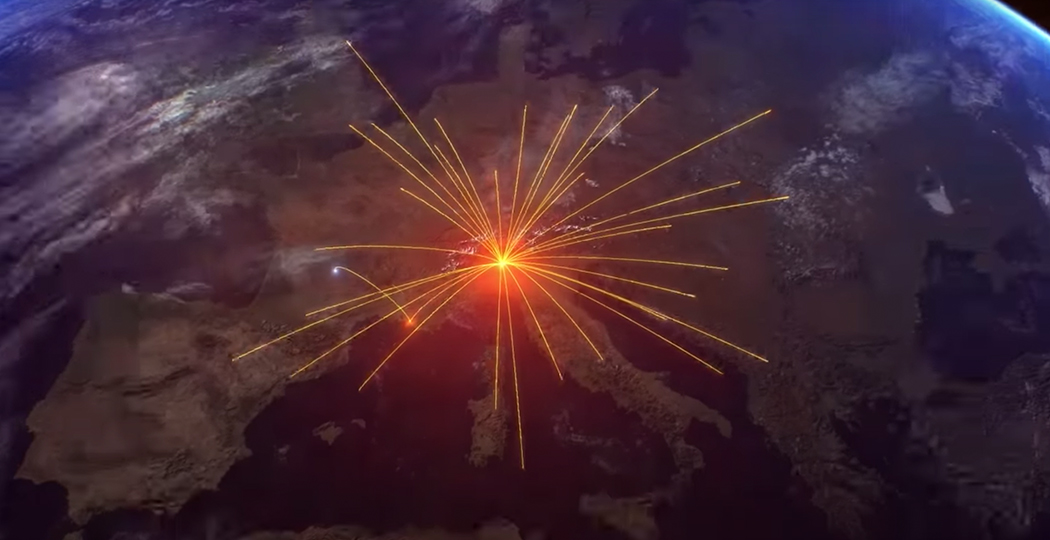 A 3D rendering of Earth that shows Europe with bright orange beams shooting out from a central point into various directions