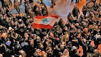 The Lebanese flag flying in the middle of a large group gathering