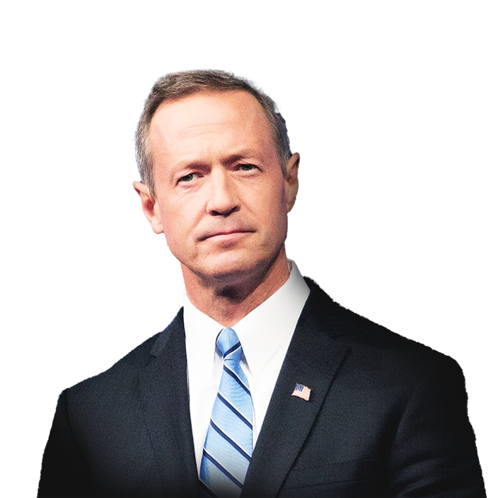 Portrait of Martin O’Malley looking intent in a blue and black suit with a long bridge over still waters in the background