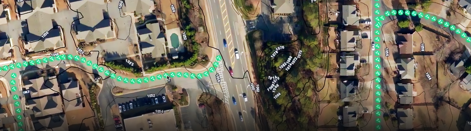 Aerial view of a suburban neighborhood overlaid with markings for routes  and coordinates