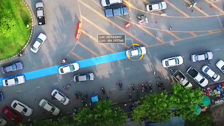 Aerial view of a street intersection overlaid with routes and coordinates
