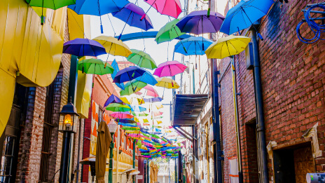 A local street with restaurants covered by suspended umbrellas