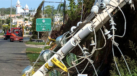 A downed powerline tower in the middle of a road after a hurricane in Puerto Rico