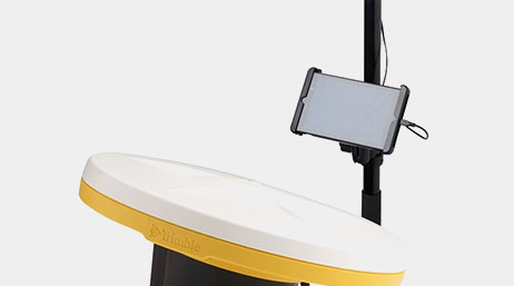 A yellow and white Trimble catalyst GNSS receiver and an Android phone attached on a pole stand