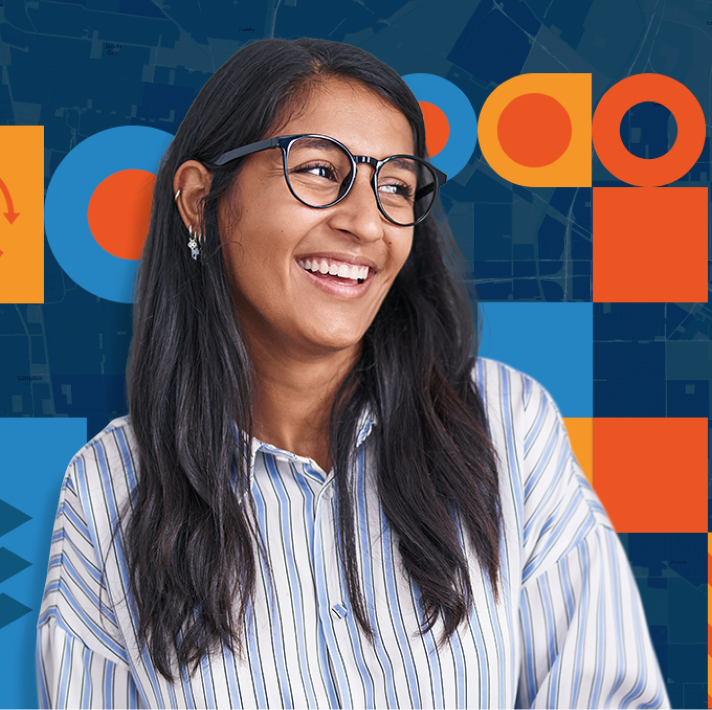 Smiling person with long dark hair and dark framed glasses wearing a striped button up shirt in front of bue and orange graphics