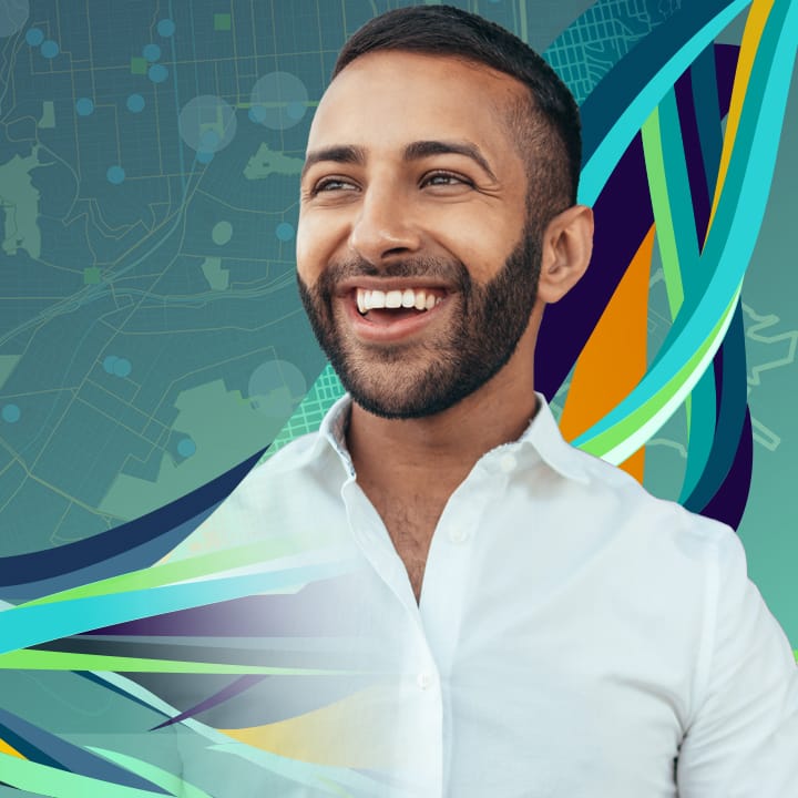 Smiling, bearded man in an open-neck white shirt against a teal background with map elements and multicolored swirls