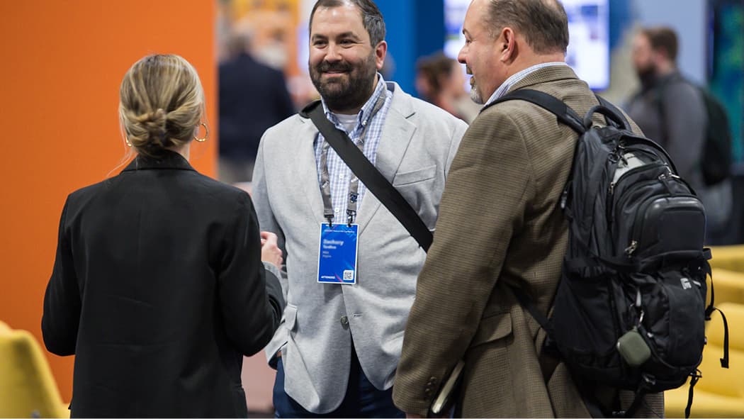 Three people in conversation at the Expo