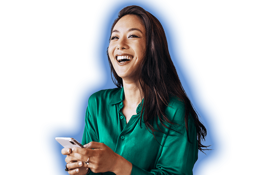 Smiling person with long dark hair wearing an emerald green blouse and holding a mobile device