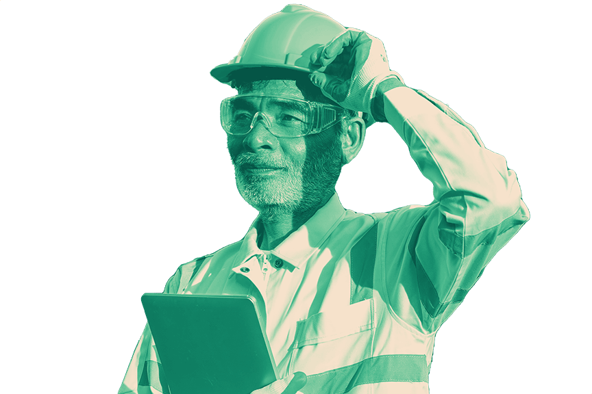 Worker wearing a shirt and tie and a hard hat holds a tablet and looks down at it