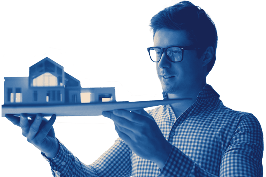 Blue-tinted photo of a man wearing glasses and a checked shirt looking at an architectural model of a building he is holding