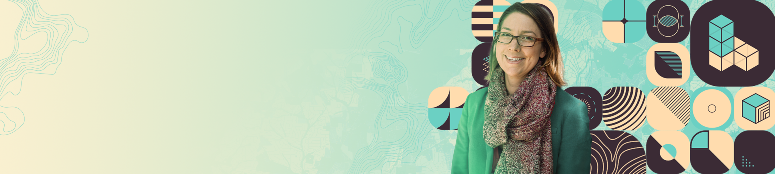 A woman wearing a green jacket and patterned scarf stands against a vibrant geometric backdrop. 