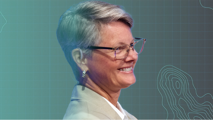 Portrait of a speaker in profile wearing glasses against a blue-green gradient background with a grid and contour map lines
