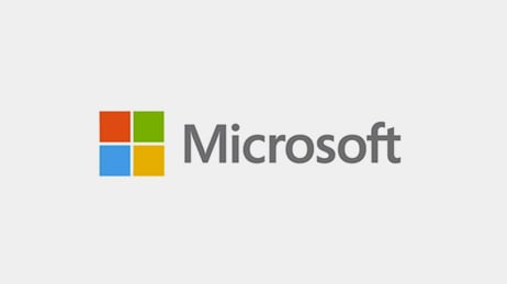 Microsoft Inc. logo: squares of red, green, blue, and yellow arranged in a square with the word Microsoft in gray to the right