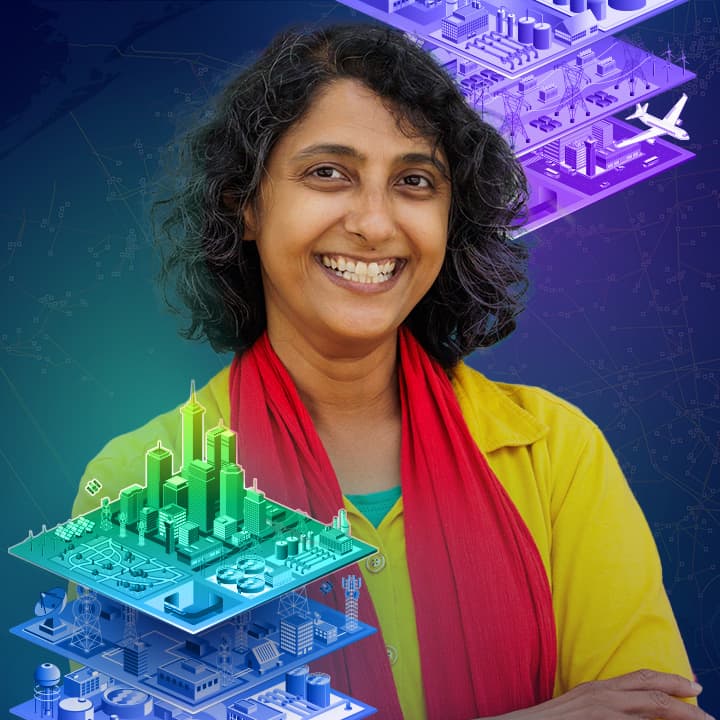 Smiling person with glasses and a beard and mustache, against a background featuring two 3D city models