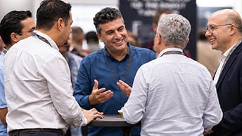 Attendee gestures with both hands during an informal group discussion