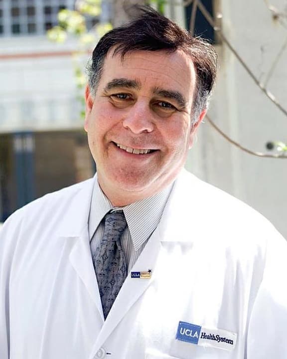 Wayne W. Grady smiling in his UCLA lab coat