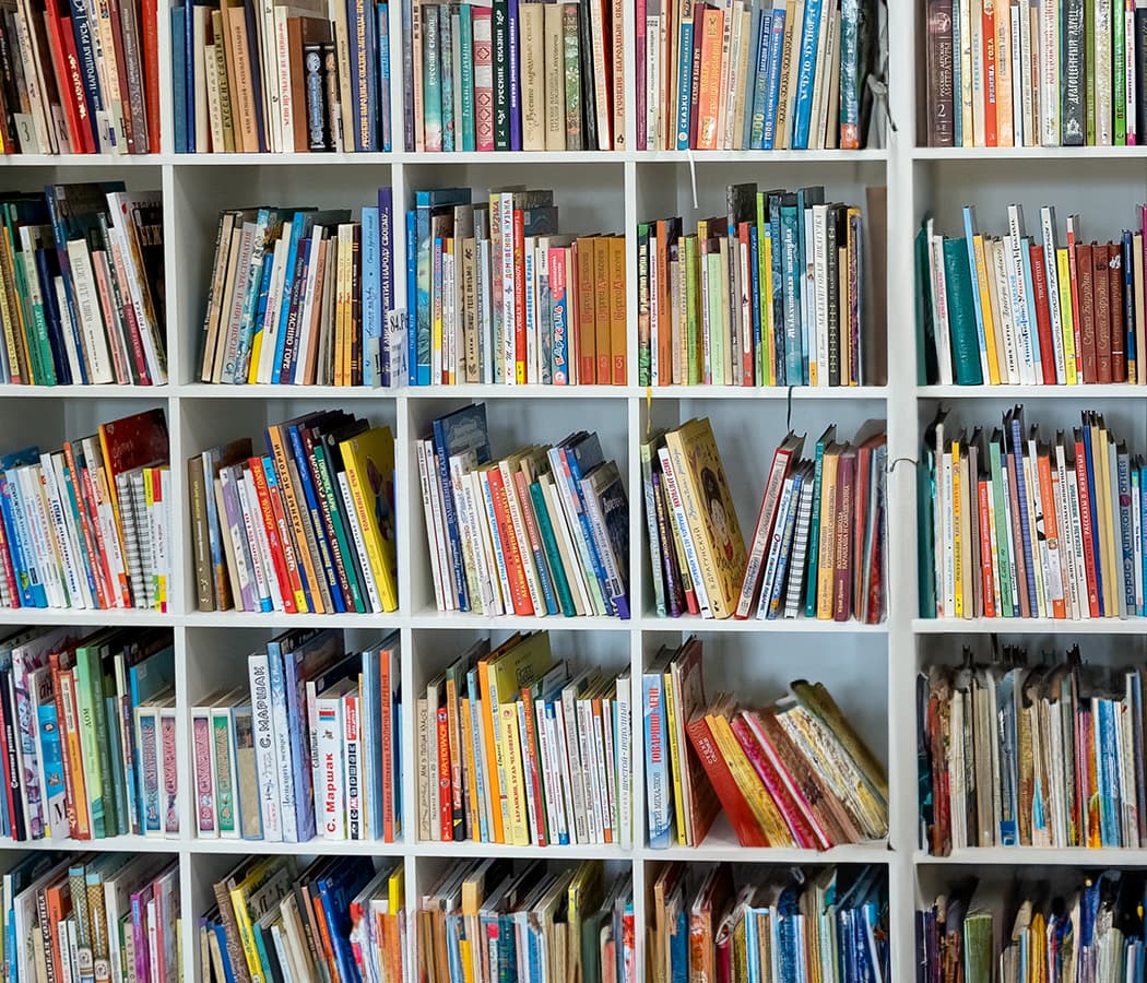 Children’s books of all sizes on shelves