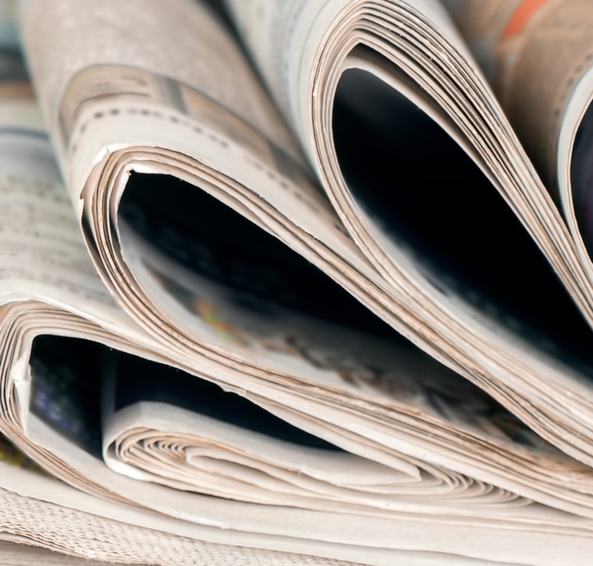 Newspapers folded in half and stacked on top of each other