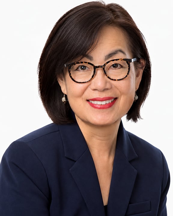 Terry Tang wearing glasses and a dark blazer