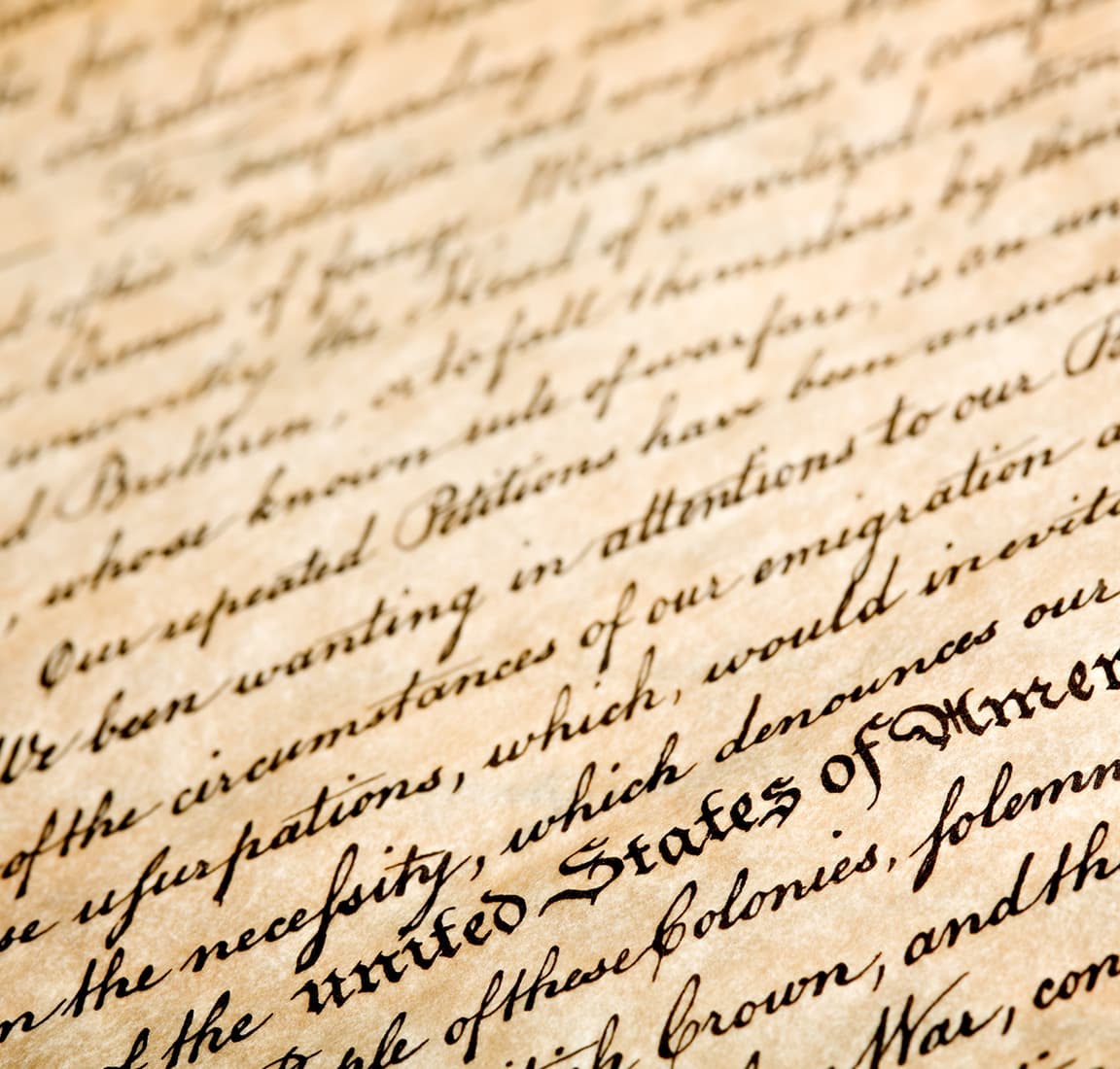 Close-up angled view of the Declaration of Independence with its elegant black cursive handwriting
