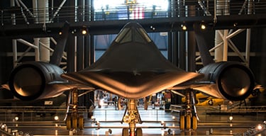 Nose-on view of an SR-71 American spy airplane in a hangar