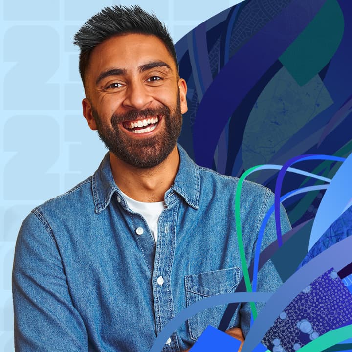 Smiling person wearing a denim button up shirt and wave graphics in shades of blue and green.