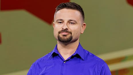 Presenter faces the audience and pauses for a question