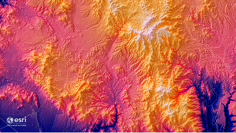 Colorful shaded relief terrain map showing mountain ridges and elevation in warm pink, orange, and purple tones