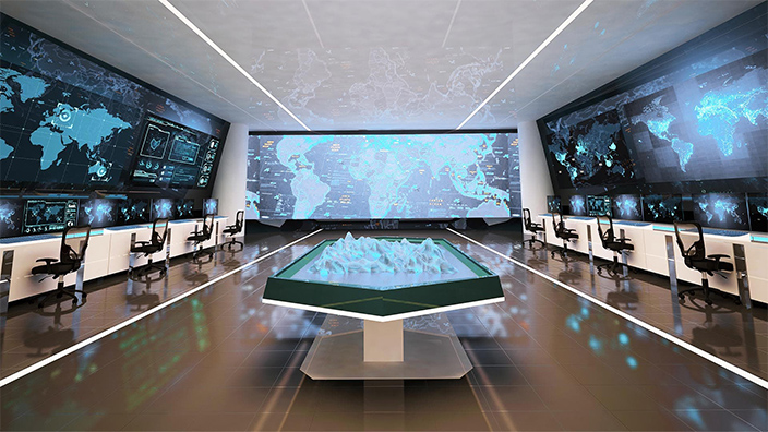 Room with several large screens covering the walls, showing sophisticated digital maps
