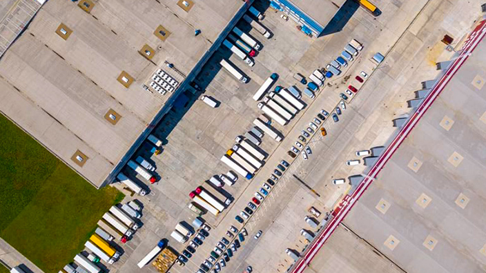 Aerial view of trucks outside a logistics warehouse