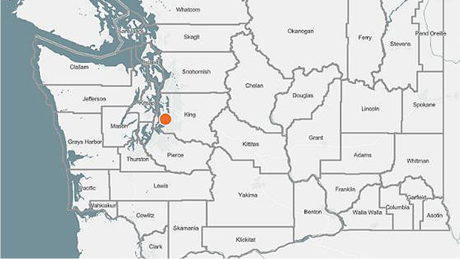 A map of county boundaries in western Washington state with a red dot over Seattle 