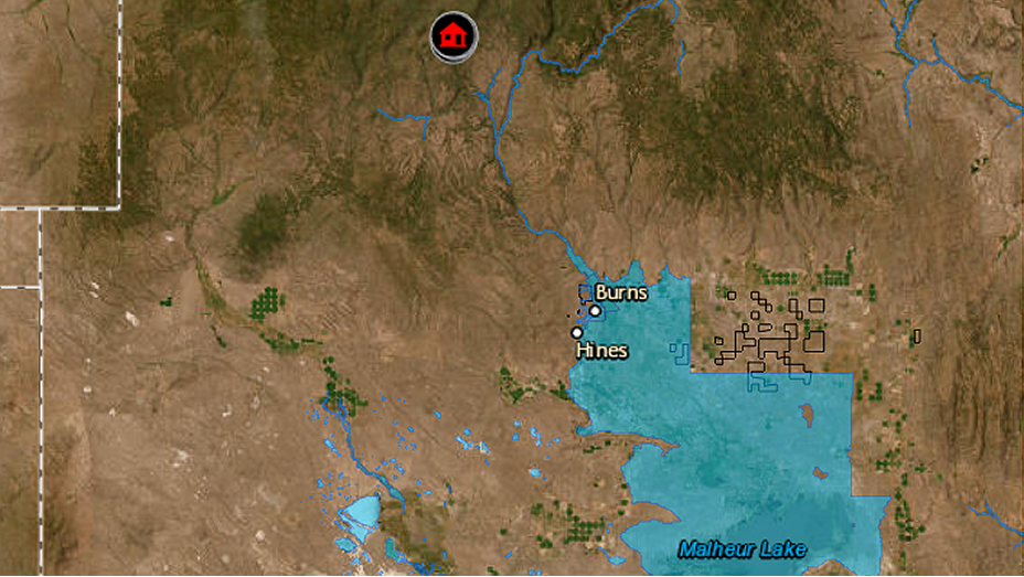 A photorealistic map identifying two cities overlaid with a transparent blue boundary