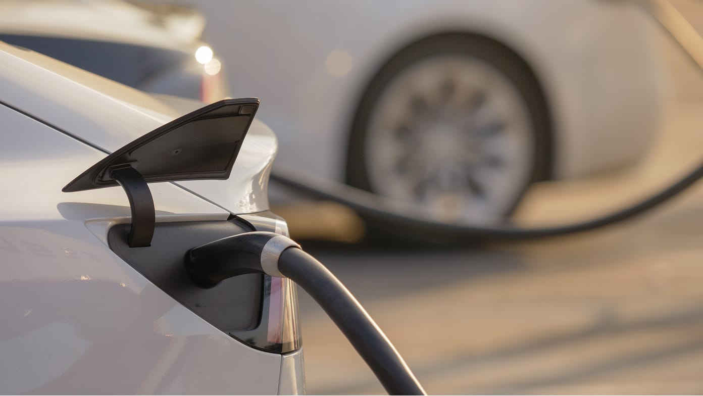Close-up view of a car’s EV charging port in use