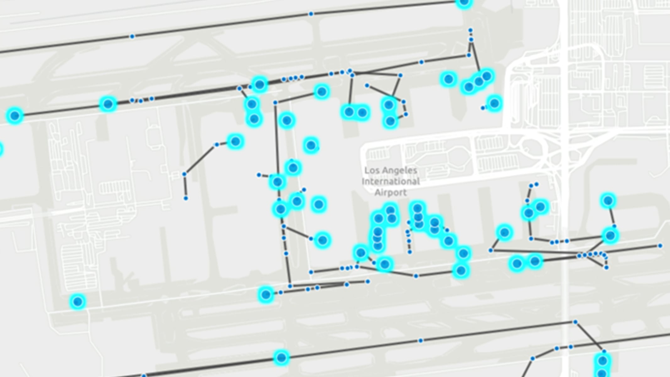 Map of a portion of Los Angeles International Airport, blue dots indicating airplane positions at various gates