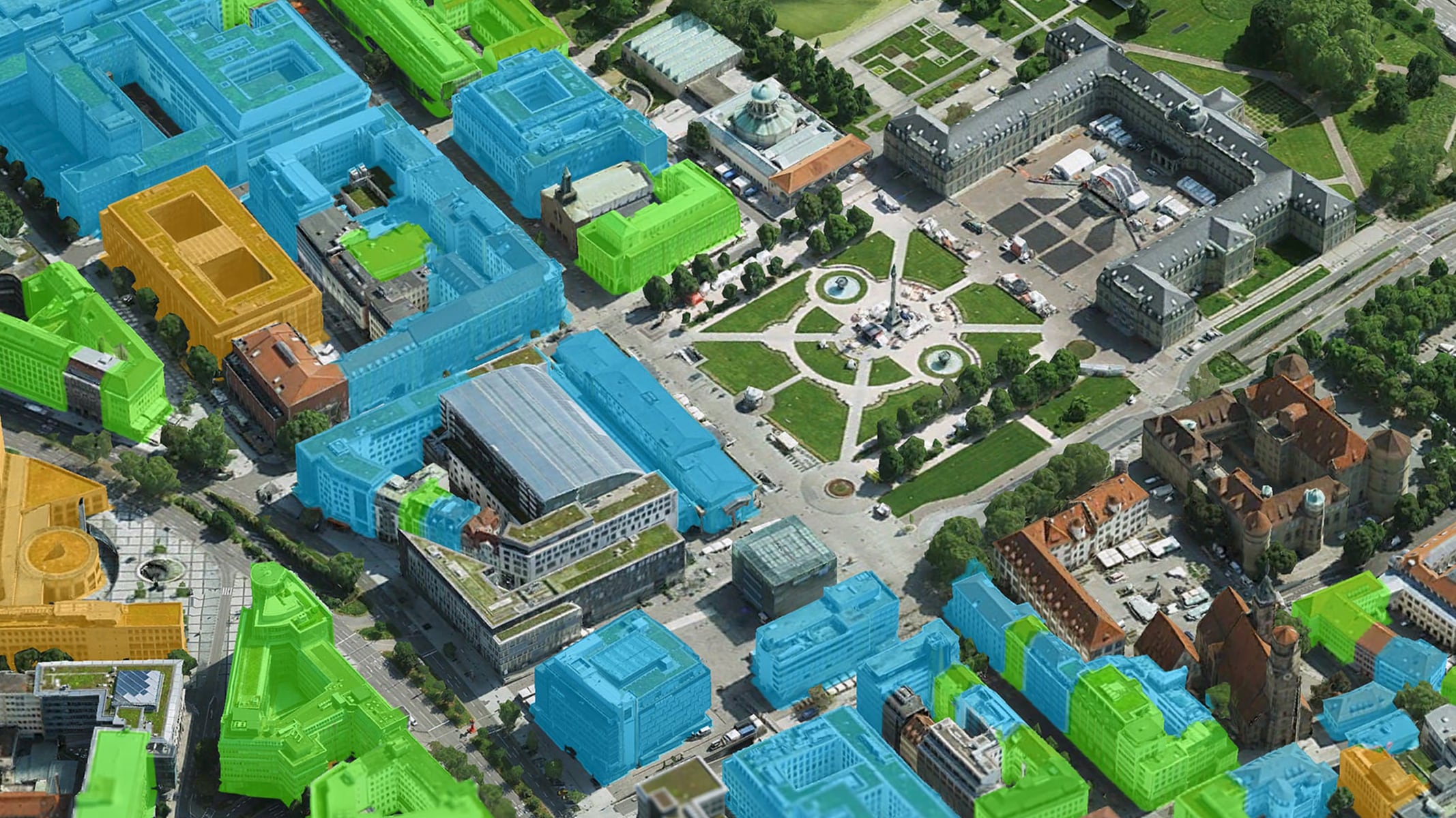 Veduta aerea di una piazza cittadina con diversi edifici evidenziati in blu, verde e oro